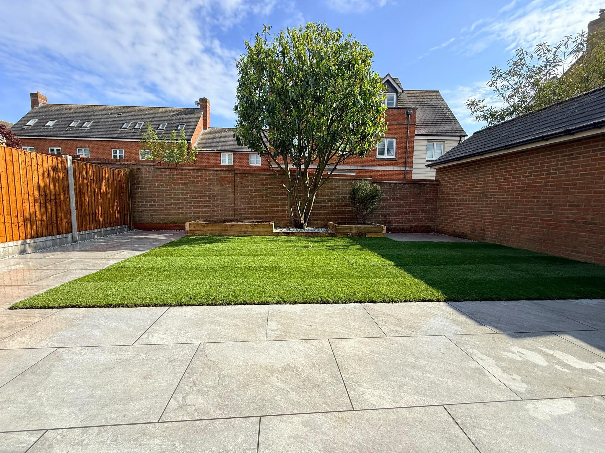 After: Modern garden with neat turf, patio tiles and raised planters on Purcell Road, Witham