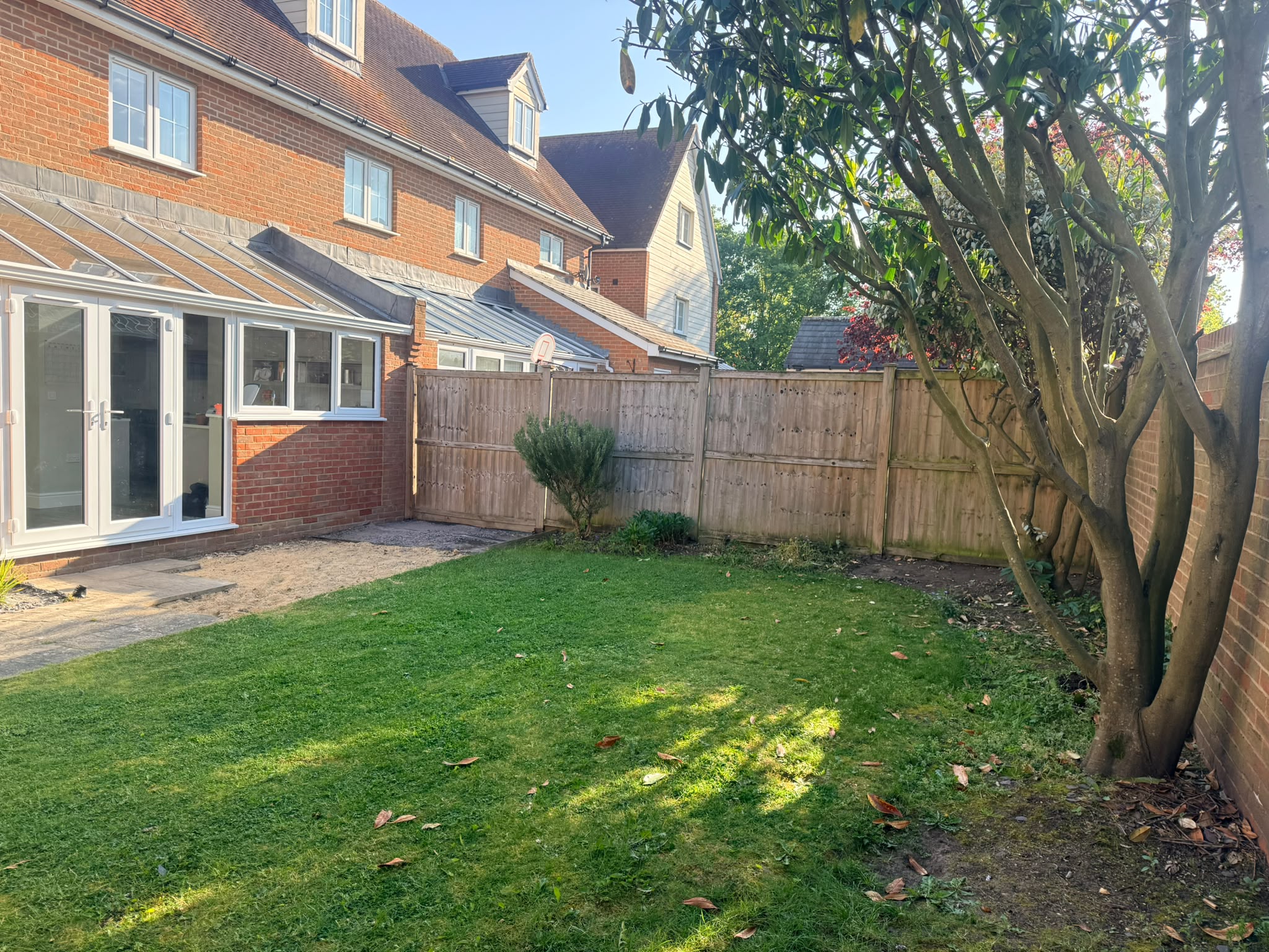 Before: Tired backyard with old lawn and uneven ground on Purcell Road, Witham