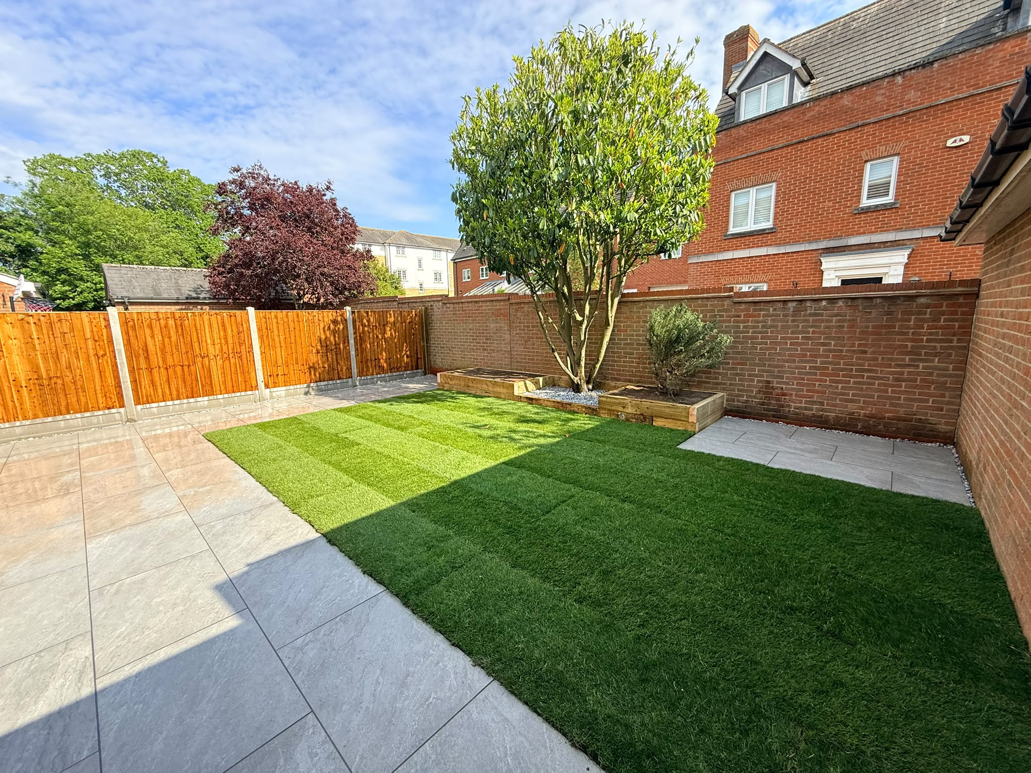 Finished garden with porcelain patio and fresh turf on Purcell Road, Witham