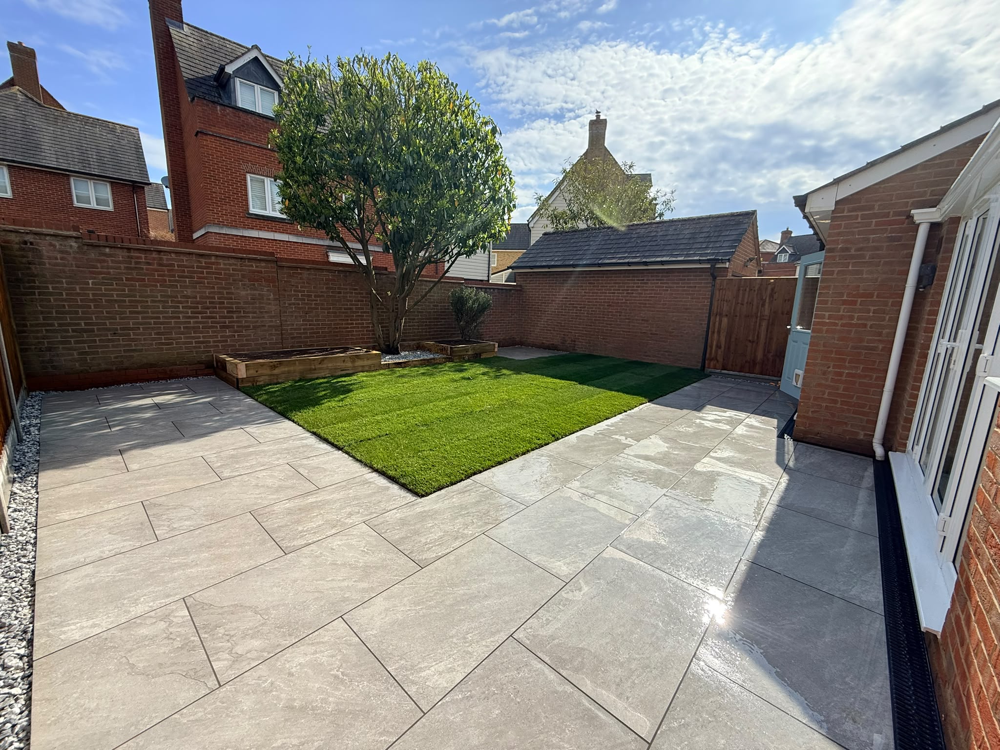 Wide porcelain patio and oak sleeper raised planters on Purcell Road, Witham