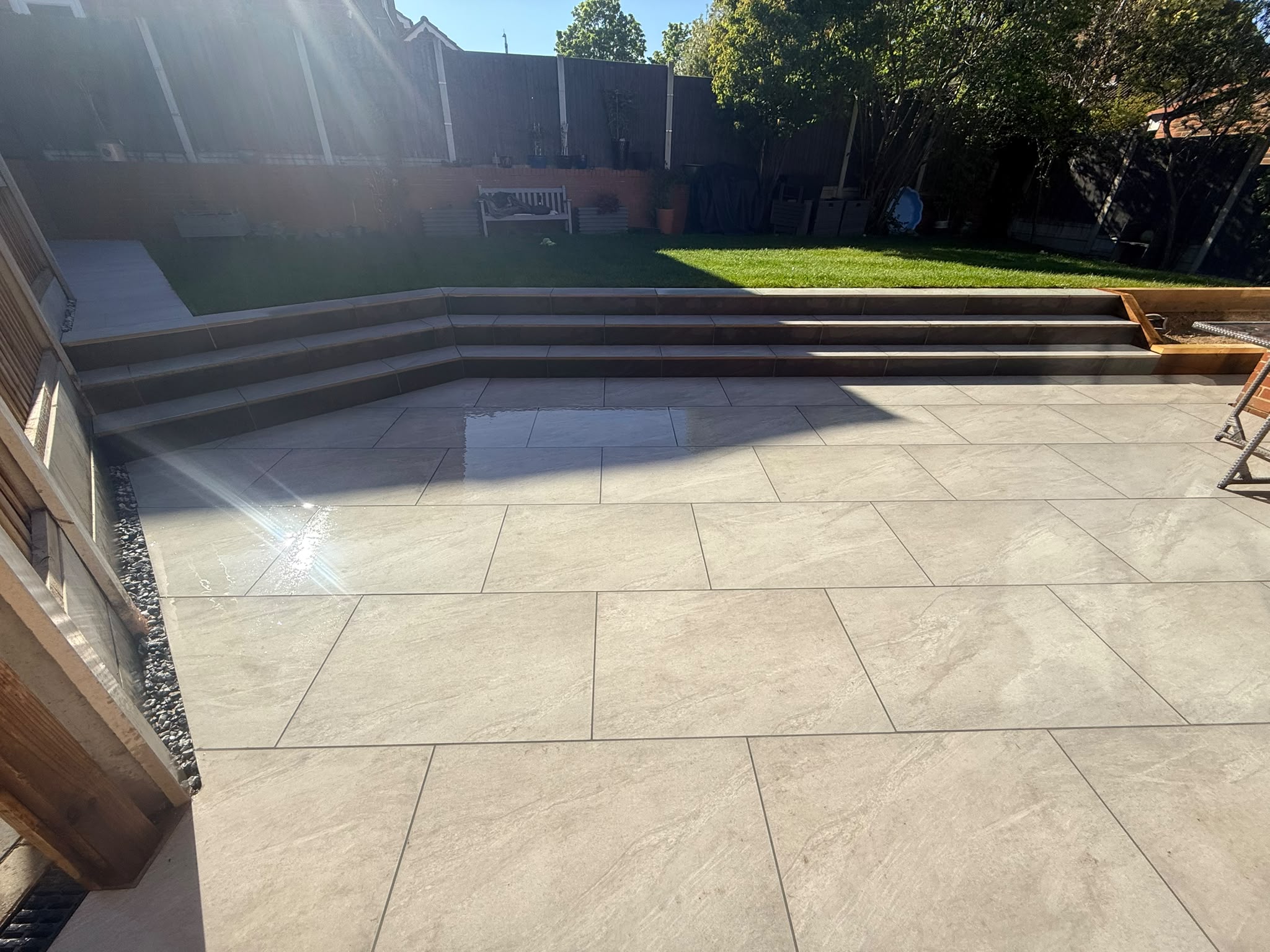 Multi-level porcelain patio and modern steps in Chelmsford